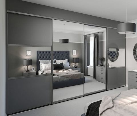 A fitted bedroom with mirrored sliding wardrobes